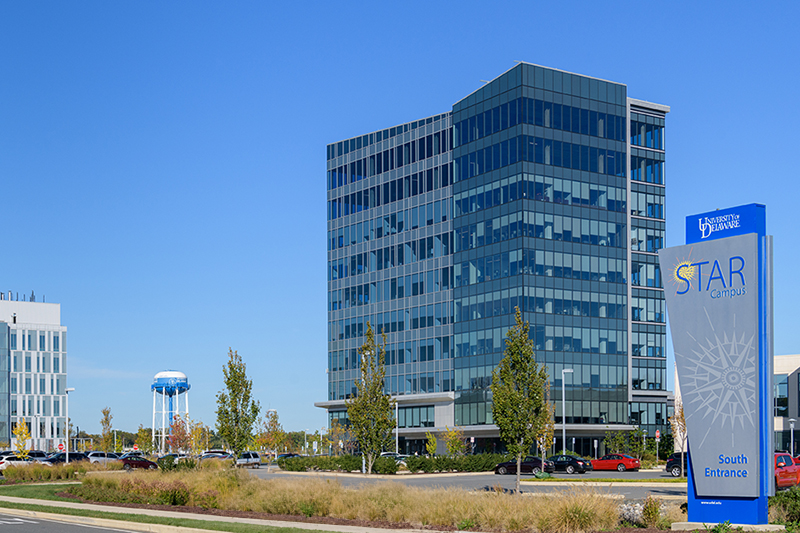 STAR Tower with a gray and blue STAR Campus sign in the foreground, located on University of Delaware Science, Technology, and Advanced Research Campus in Newark, Delaware.